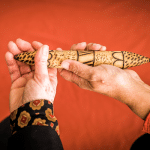 Passing a talking stick between hands demonstrating acceptance and reconciliation