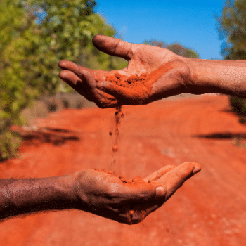 Showing Aboriginal hands holding red earth