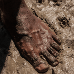 Aboriginal bare foot in mud