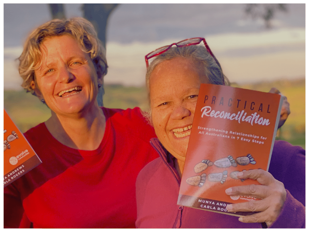 Carla and Aunty Munya holding up their book, Practical Reconciliation