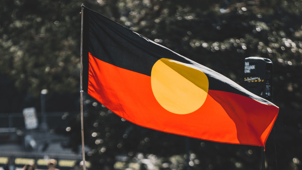 Protestor flying the Aboriginal flag on Australia Day.