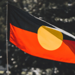 Protestor flying the Aboriginal flag on Australia Day.