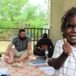 Cute Aboriginal Boy and others sitting in circle