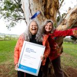 Aunty Munya and Carla holding up their Telstra Best of Business Award