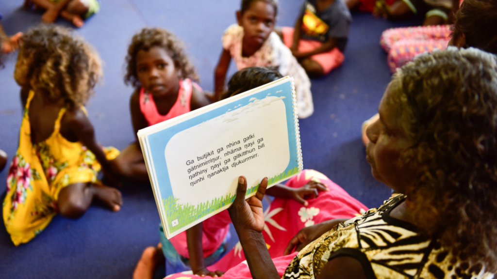 indigenous Literacy Day: Picture of First Nations woman reading to children in Aboriginal language