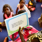 indigenous Literacy Day: Picture of First Nations woman reading to children in Aboriginal language