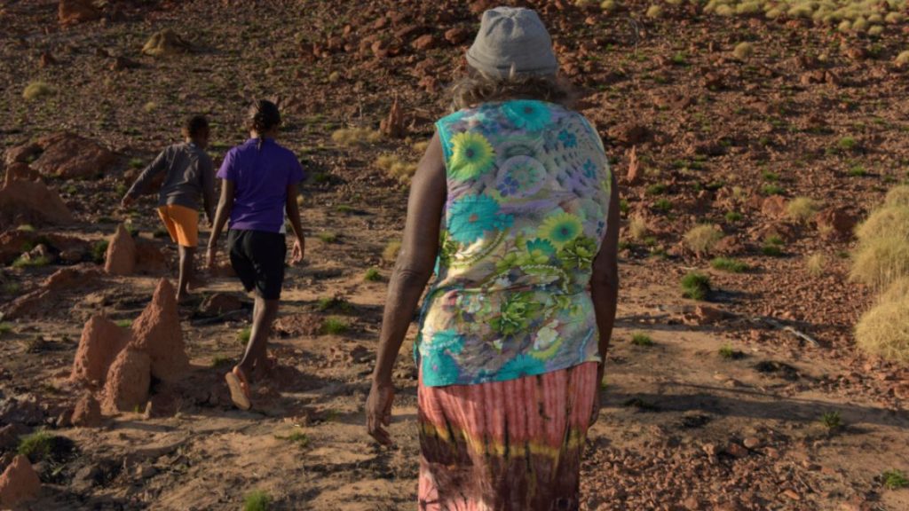 Political issues effecting Aboriginal people: Image of an Aboriginal Elder and children on Country