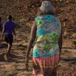 Political issues effecting Aboriginal people: Image of an Aboriginal Elder and children on Country