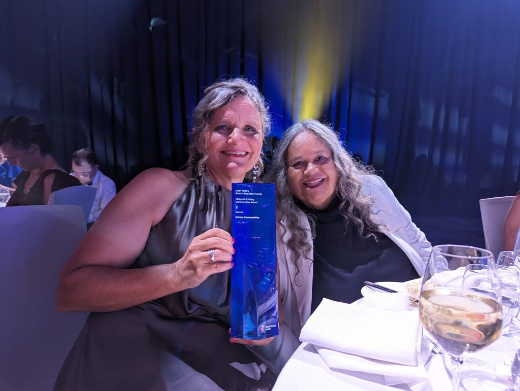 Aunty Munya and Carla holding up their Tesltra Best of Business Trophy