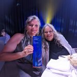 Aunty Munya and Carla holding up their Tesltra Best of Business Trophy
