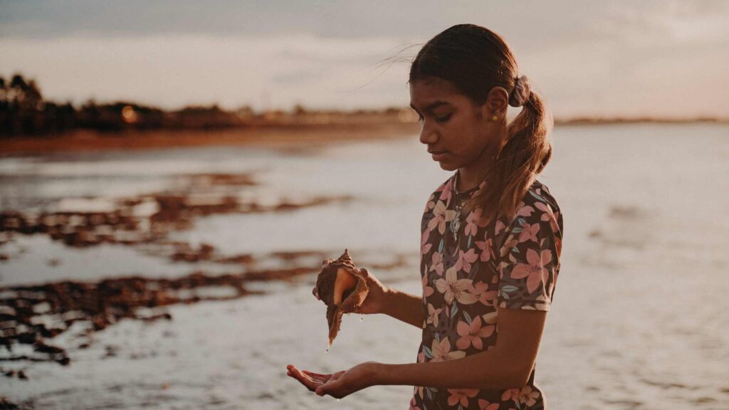 How to Embed Allyship into Your Organisation Evolve Communities Aboriginal girl on a beach Cultural Awareness